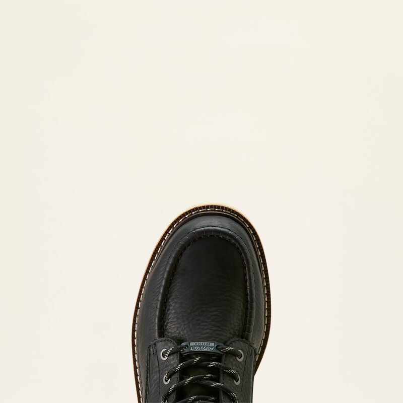 Black leather shoe on a beige background