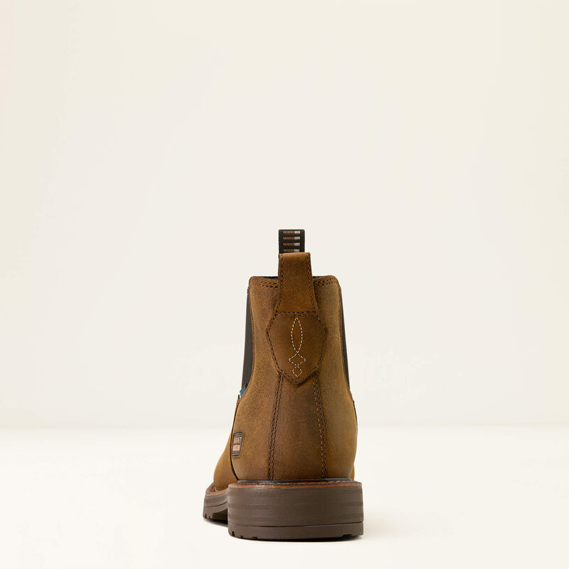 Brown leather boot with a strap on a white background