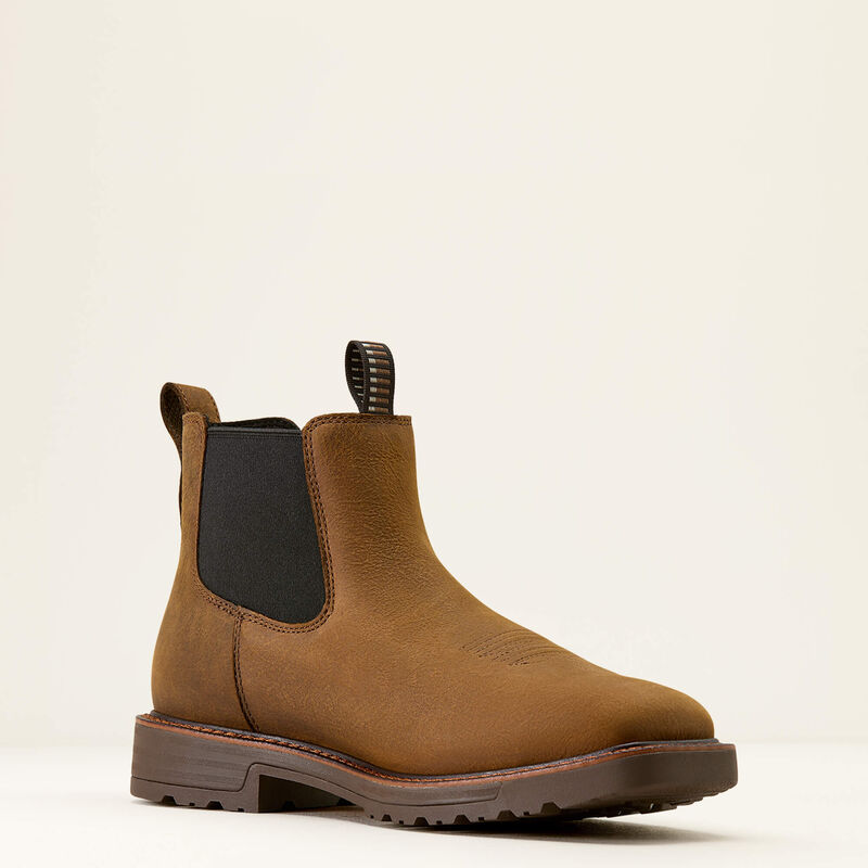 Brown Chelsea boot on a beige background