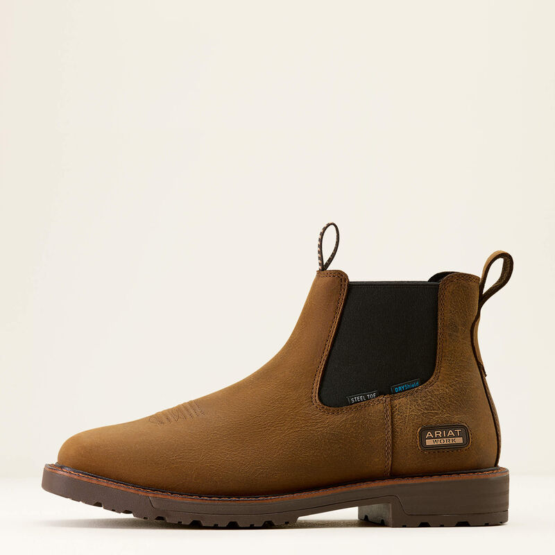 Brown leather boot with black patch on a beige background
